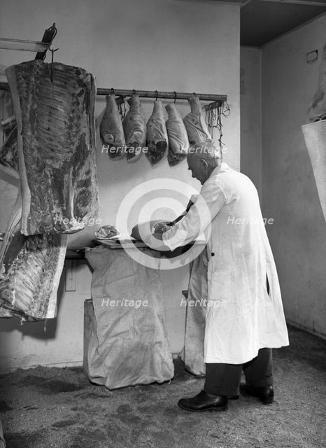 Dressing meat for sale, Rawmarsh, South Yorkshire, 1955. Creator: Michael Walters.