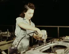 Drilling a wing bulkhead for a transport plane at the Consolidated Air..., Fort Worth, Texas, 1942. Creator: Howard Hollem