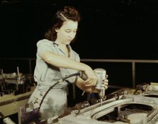 Drilling a wing bulkhead for a transport plane at the Consolidated Air..., Fort Worth, Texas, 1942. Creator: Howard Hollem