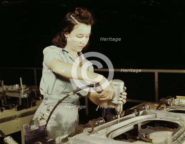 Drilling a wing bulkhead for a transport plane at the Consolidated Air..., Fort Worth, Texas, 1942. Creator: Howard Hollem.