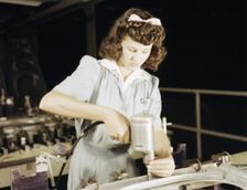 Drilling a wing bulkhead for a transport plane at the Consolidated Air..., Fort Worth, Texas, 1942. Creator: Howard Hollem