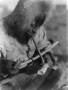 Drilling ivory-King Island, c1929. Creator: Edward Sheriff Curtis