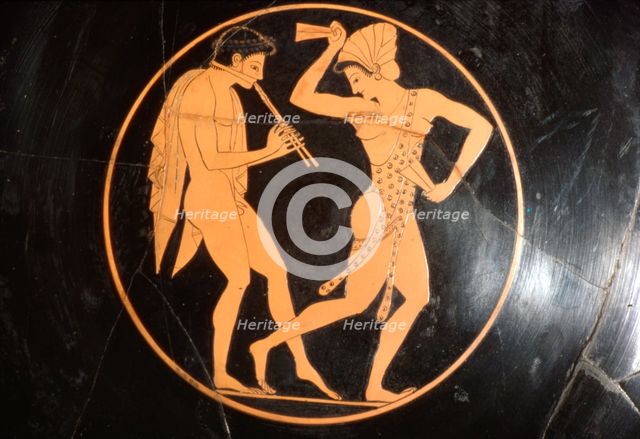 Drinking Cup, (Kylix) of Girl Dancing with Youth Playing Flute, Attic, c510 BC Artist: Epikektos.