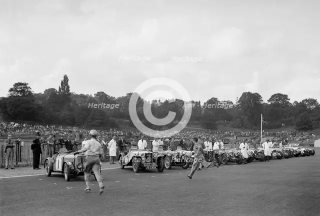 Drivers running to their cars at the start of the Imperial Trophy race, Crystal Palace, 1939. Artist: Bill Brunell.