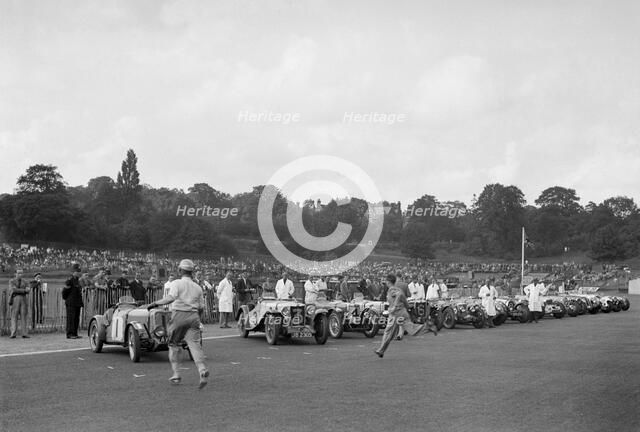 Drivers running to their cars at the start of the Imperial Trophy race, Crystal Palace, 1939. Artist: Bill Brunell.