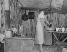 Drought refugee living in a ditch bank camp, Imperial County, California, 1937. Creator: Dorothea Lange