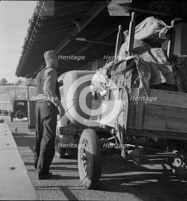 Drought refugees are stopped at the inspection station in Yuma, Arizona, 1937. Creator: Dorothea Lange.