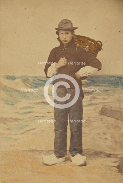Dutch boy in front of painted sea background, 1865-1875. Creator: Willem Frederik Vinkenbos.