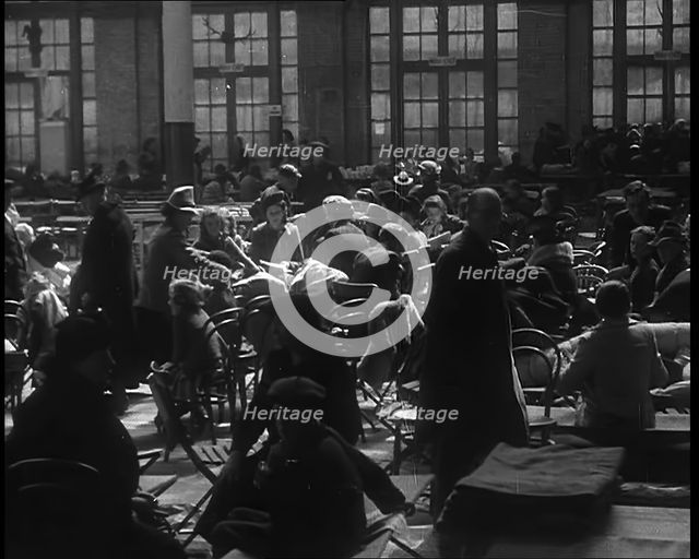 Dutch Refugees Sitting and Eating at a Reception Centre in the United Kingdom, 1940. Creator: British Pathe Ltd.