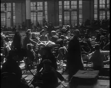 Dutch Refugees Sitting and Eating at a Reception Centre in the United Kingdom, 1940. Creator: British Pathe Ltd