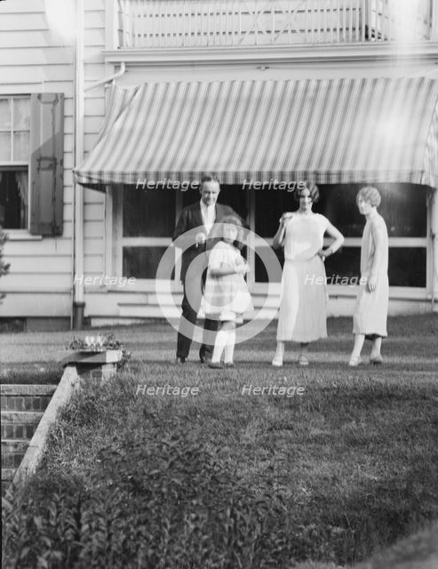 Dunning family, standing outside house, 1925 July 9. Creator: Arnold Genthe.