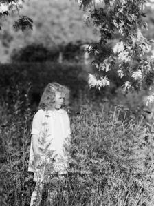 Dunning, Mr., daughter of, standing in a garden, 1925 July 9. Creator: Arnold Genthe
