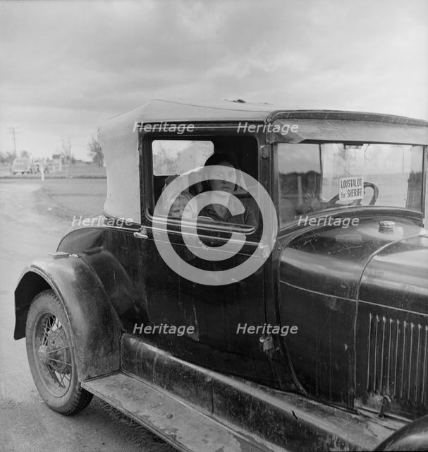 During the cotton strike, a striking picker applies for an emergency food grant, Shafter, CA, 1938. Creator: Dorothea Lange.