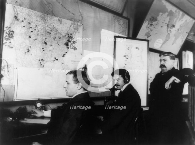 E.C. Heasley, Jules A. Rodier and Maj. Montgomery in the telegraph room in the White House..., 1898. Creator: Frances Benjamin Johnston.