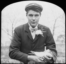 E Hack holding a pigeon, late 19th or early 20th century