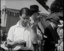 Emlyn Williams, Actor, Timing Punters by the Fishing for Fizz Stall at the Theatrical..., 1939. Creator: British Pathe Ltd