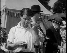 Emlyn Williams, Actor, Timing Punters by the Fishing for Fizz Stall at the Theatrical..., 1939. Creator: British Pathe Ltd