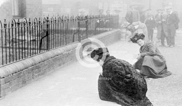 Emma Sproson (left) and a friend chalking the pavement, 1907. Creator: Unknown.