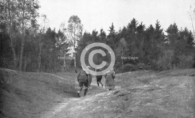 ''En Foret D'Argonne; Passage dangereux a travers une clairiere', 1915. Creator: Unknown.