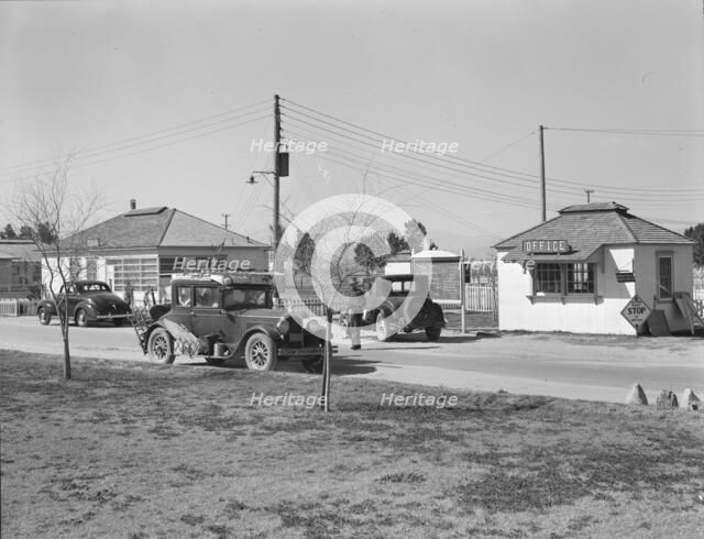 Entering FSA camp for migratory laborers at Indio, Coachella Valley, CA, 1939. Creator: Dorothea Lange.