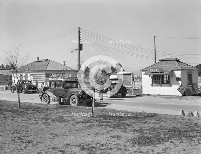 Entering FSA camp for migratory laborers at Indio, Coachella Valley, CA, 1939. Creator: Dorothea Lange.