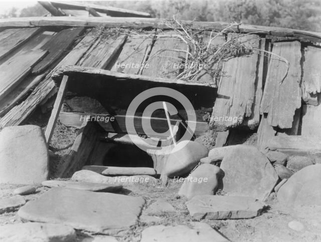Entrance to a Yurok Sweat-house, c1923. Creator: Edward Sheriff Curtis.