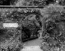 Entrance to the herb garden in Wardrobe Court, Hampton Court Palace, Richmond, London. Artist: Alfred Newton & Sons