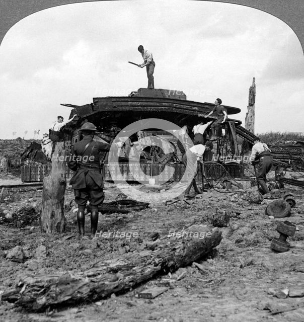 Engineers clearing a destroyed tank from a road, World War I, 1917-1918.Artist: Realistic Travels Publishers