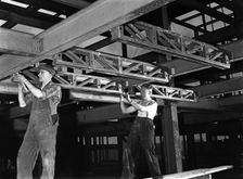 Engineers lifting steelwork into position, South Yorkshire, 1954. Creator: Michael Walters
