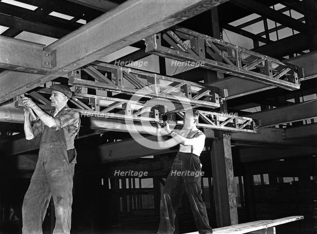 Engineers lifting steelwork into position, South Yorkshire, 1954. Creator: Michael Walters.