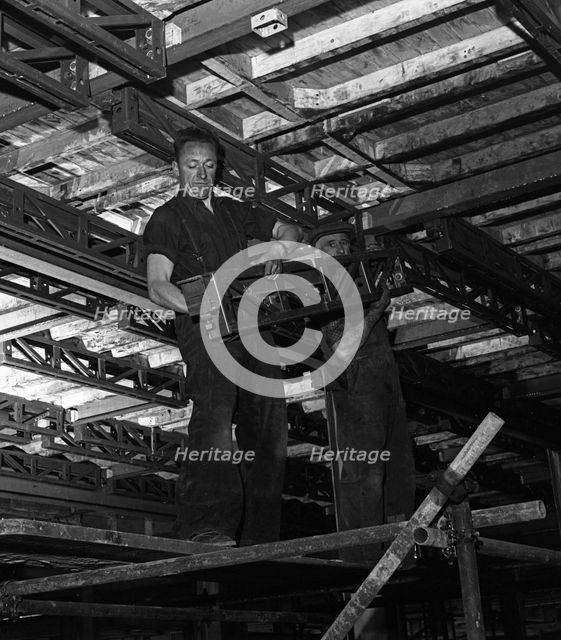 Engineers lifting steelwork into position, South Yorkshire, 1954. Creator: Michael Walters.