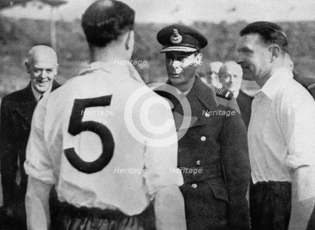 English footballer Eddie Hapgood meeting King George VI, c1937-c1944. Artist: Unknown