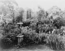 English lead figurine holding sundial, Graham Nichols garden, Greenwich, Connecticut, c1908 - 1927. Creator: Frances Benjamin Johnston