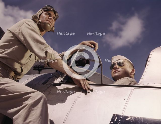 Ens[ign] Noressey and Cadet Thenics at the Naval Air Base, Corpus Christi, Texas, 1942. Creator: Howard Hollem.