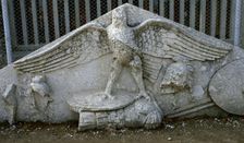 Eagle figure, armour, spear, helmet and circular shield, Roman gable, Side, Turkey, 1999. Creator: LTL