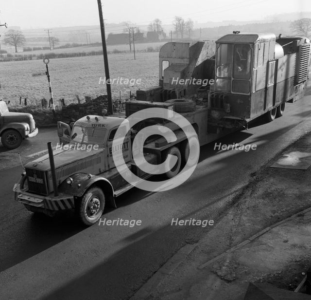 Early 1940s Diamond T truck pulling a large load, South Yorkshire, 1962. Artist: Michael Walters