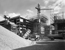 Early 1950s Bedford M Tipper delivering aggregates to a building site, South Yorkshire, July 1954. Creator: Michael Walters