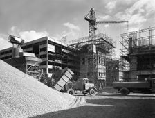 Early 1950s Bedford M Tipper delivering aggregates to a building site, South Yorkshire, July 1954. Creator: Michael Walters