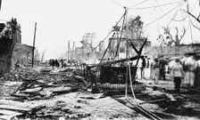 Earthquake damage and a burnt car, King Street, Kingston, Jamaica, 1907