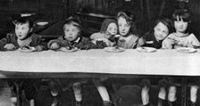 East End children being fed by a charitable organisation, London, 1926-1927