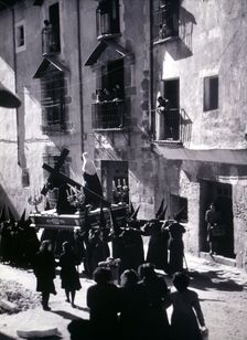 Easter procession along a street in Cuenca, photography of the 50s
