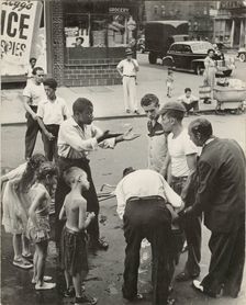 Eastside - Group of men and youths gathered around an accident victim; one young..., 1947 - 1951. Creator: Romulo Lachatanere
