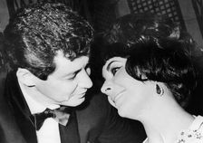 Eddie Fisher and his wife, Elizabeth Taylor, at a party in Rome, 1961