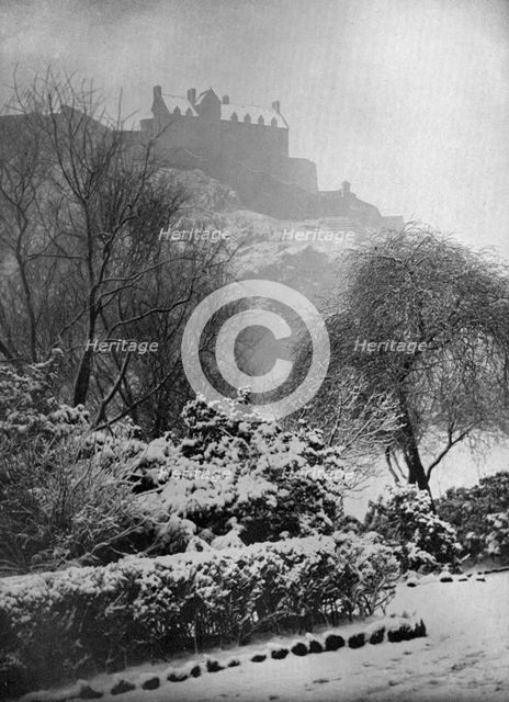 Edinburgh Castle in the snow, from Princes Street Gardens, Scotland, 1924-1926.Artist: W Reid