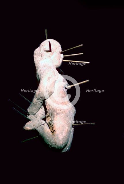 Egyptian clay figure stuck with pins. Artist: Unknown