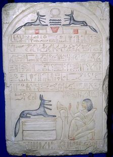 Egyptian elief stele of a man adoring Anubis