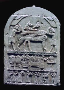 Egyptian stele showing Anubis preparing a mummy