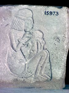 Egyptian relief of a woman suckling a child, 14th century BC
