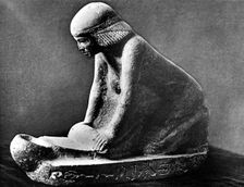 Egyptian tomb figure of a woman grinding corn using a saddle quern, c2500 BC