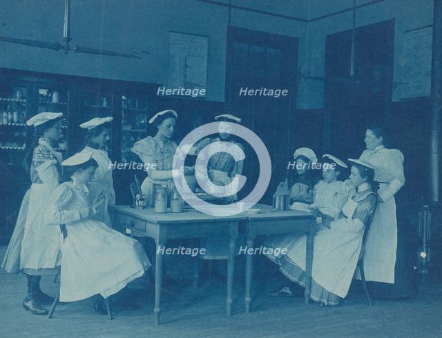 Eight teenage girls wearing aprons and chef caps learning to cook...Washington DC high school, 1899? Creator: Frances Benjamin Johnston.